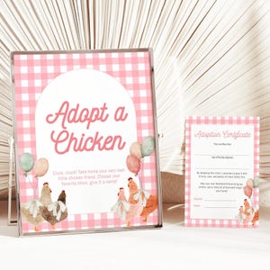 May include: A framed sign and adoption certificate with a pink gingham pattern. The sign reads "Adopt a Chicken" with illustrations of chickens and balloons. The certificate has space for details and promises love and care.