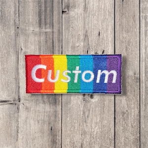 May include: A rainbow-coloured fabric patch with the word "Custom" embroidered in white.