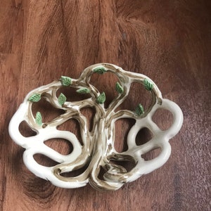 May include: White ceramic dish shaped like a tree with brown branches and green leaves.