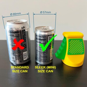 May include: Image showing a comparison of a standard size can (66mm diameter) and a sleek (mini) size can (57mm diameter). A yellow and green can opener is also present. The text reads "STANDARD SIZE CAN" and "SLEEK (MINI) SIZE CAN".