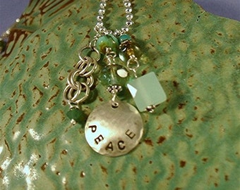 Hand Hammered Peace Hand Stamped Sterling Silver Disc Necklace. Dangles from sterling silver ball chain with unique deep crystals