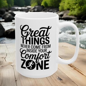 May include: White ceramic mug with a black motivational quote: "Great things never come from inside your comfort zone." The mug features a black graphic of a person running inside the word "zone".