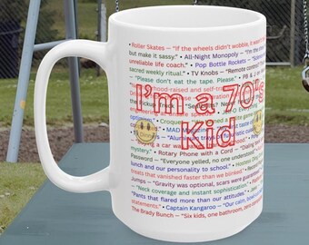 May include: White ceramic mug with the text "I'm a 70's Kid" in a colorful, retro font. The mug is covered with phrases and quotes from the 1970s, making it a nostalgic gift for anyone who grew up in that era.