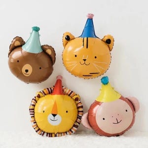 May include: Four animal-shaped foil balloons: a brown bear, an orange tiger, a yellow lion, and a brown monkey. Each balloon has a party hat in various colors. The balloons are designed for a birthday or celebration.