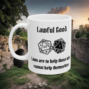 May include: White ceramic mug with a black and white illustration of two dice. The text "Lawful Good" is printed above the dice and the text "Laws are to help those who cannot help themselves" is printed below the dice.