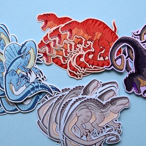 May include: A set of colorful dinosaur stickers featuring a blue dinosaur with a frill, a red dinosaur, a gray dinosaur, and a black dinosaur. The stickers are perfect for adding a fun and whimsical touch to any project.