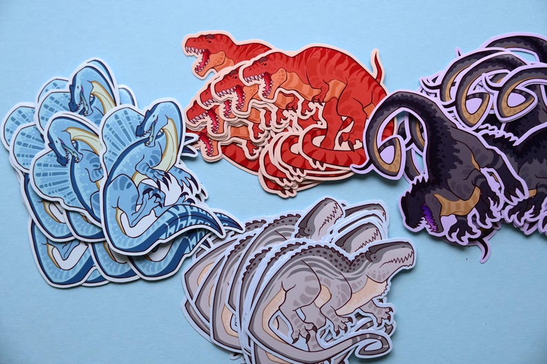 May include: A set of colorful dinosaur stickers featuring a blue dinosaur with a frill, a red dinosaur, a gray dinosaur, and a black dinosaur. The stickers are perfect for adding a fun and whimsical touch to any project.
