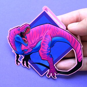 May include: A pink and blue dinosaur sticker with the text "Bi-rannosaurus rex" in a diamond shape.