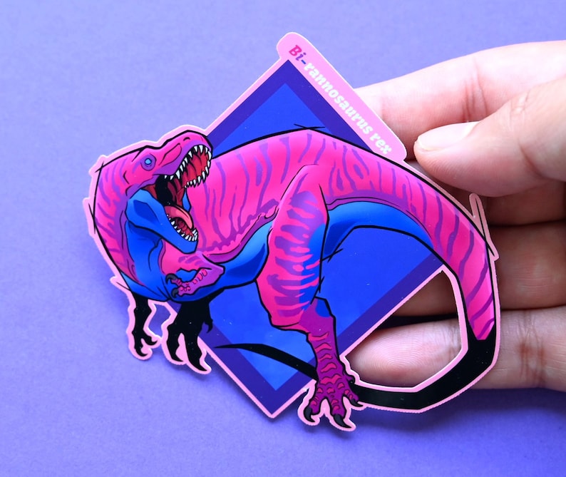 May include: A pink and blue dinosaur sticker with the text "Bi-rannosaurus rex" in a diamond shape.