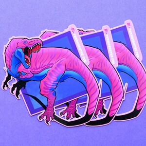 May include: Three pink and blue dinosaur stickers with the text "Bi-Panicosaurus Rex" on each sticker.