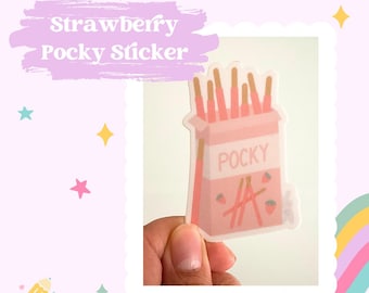 Puede incluir: Una pegatina rosa y blanca con una caja de Pocky de fresa. La caja tiene la palabra "POCKY" impresa en letras blancas. Hay varios palitos de Pocky de fresa dentro de la caja.