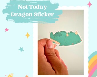 May include: A green and yellow cartoon dragon sticker with the text "Not Today" on a white background. The sticker is being held by a hand.