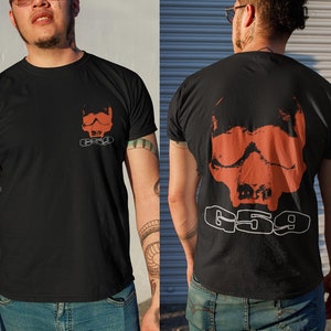 May include: Black t-shirt with a red skull graphic and the text "659" printed on the back.