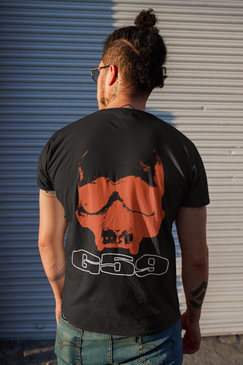 May include: A black t-shirt featuring a large orange skull graphic and the text "G59" printed in white on the back.