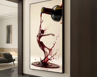 May include: A framed art print depicts a dancer formed from a splash of red wine. A bottle pours the wine, creating the dancer's form. The artwork is set against a cream background, with a black frame. The image is a creative representation of wine and dance.