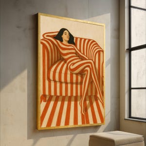 May include: A framed artwork featuring a person reclining in a striped chair. The person and chair share a matching red and cream stripe pattern. The artwork is in a gold frame and hangs on a neutral wall.