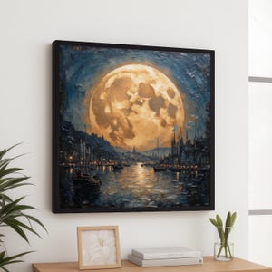 May include: Square framed art print of a moonlit harbor scene. The artwork features a large, golden moon dominating the night sky above a body of water with boats and buildings. The painting is in shades of blue, gold, and brown.