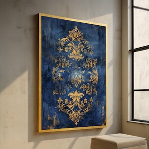 May include: A framed wall art piece featuring a dark blue background with a gold ornate design. The gold design is a repeating pattern of floral and scroll elements. The frame is gold. The artwork is rectangular and hung on a wall.