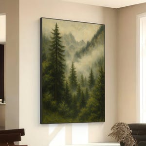 May include: A framed landscape painting depicting a misty forest scene. The artwork features tall evergreen trees in varying shades of green, with mountains in the background shrouded in fog. The painting is displayed on a beige wall.