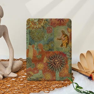 Puede incluir: Una funda rectangular y multicolor para tableta con un collage de soles, figuras y una tortuga tocando un instrumento de cuerda. La funda tiene un aspecto vintage texturizado con una mezcla de tonos naranja, verde y azul. Se muestra sobre una estera tejida.