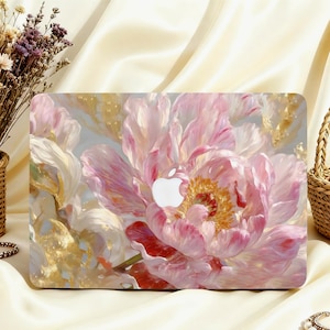 May include: A laptop case featuring a large, detailed floral design. The artwork showcases a pink peony with gold accents and a white Apple logo. The case is set against a cream-colored background.