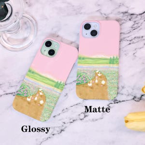 May include: Two pink iPhone cases with a design of ducks walking in a field of flowers. The case on the left is glossy and the case on the right is matte. The text "Glossy" is below the left case and the text "Matte" is below the right case.