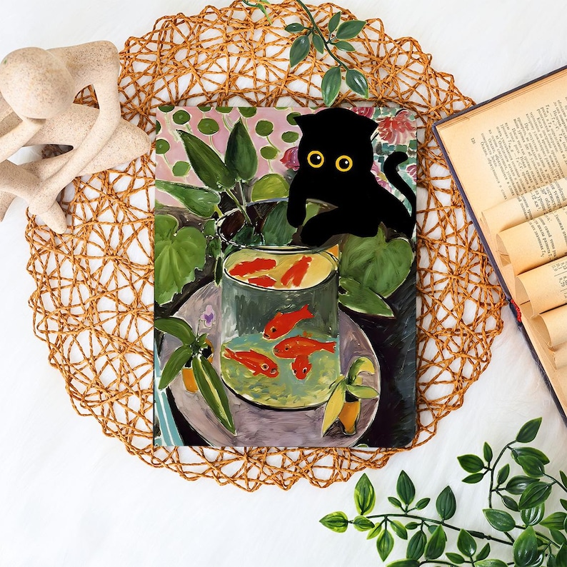 May include: A colorful painting of goldfish in a glass bowl, with a black cat silhouette perched above. The artwork features vibrant red fish, green plants, and a pink and green background, set on a woven placemat.