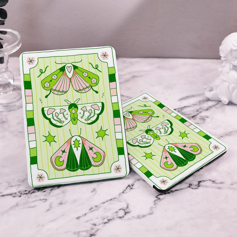 May include: Two white covers with green and pink butterfly illustrations. The covers have a green and white striped border with a pink and white checkered border. The covers have the text "*" on the bottom right corner.