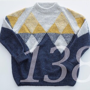 May include: A blue and white sweater with a yellow diamond pattern. The sweater has a crew neck and long sleeves.