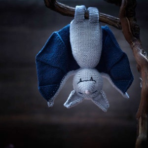 Knitted bat toy hanging upside down