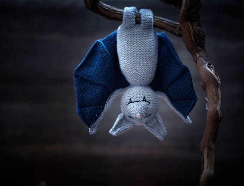 Knitted bat toy hanging upside down