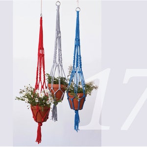 May include: Three macrame plant hangers, one red, one blue and one grey, each holding a potted plant.