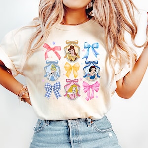 Coquette Bows Watercolor Disney Princess Shirt, Disney Aurora Ariel Belle Cinderella Tiana Shirt, Magic Kingdom Disneyland Girl Trip 2025