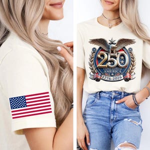 May include: Cream-colored t-shirt featuring a graphic commemorating the 250th anniversary of the United States of America. The design includes an eagle, stars, and the years 1776-2026. The sleeve displays a US flag.