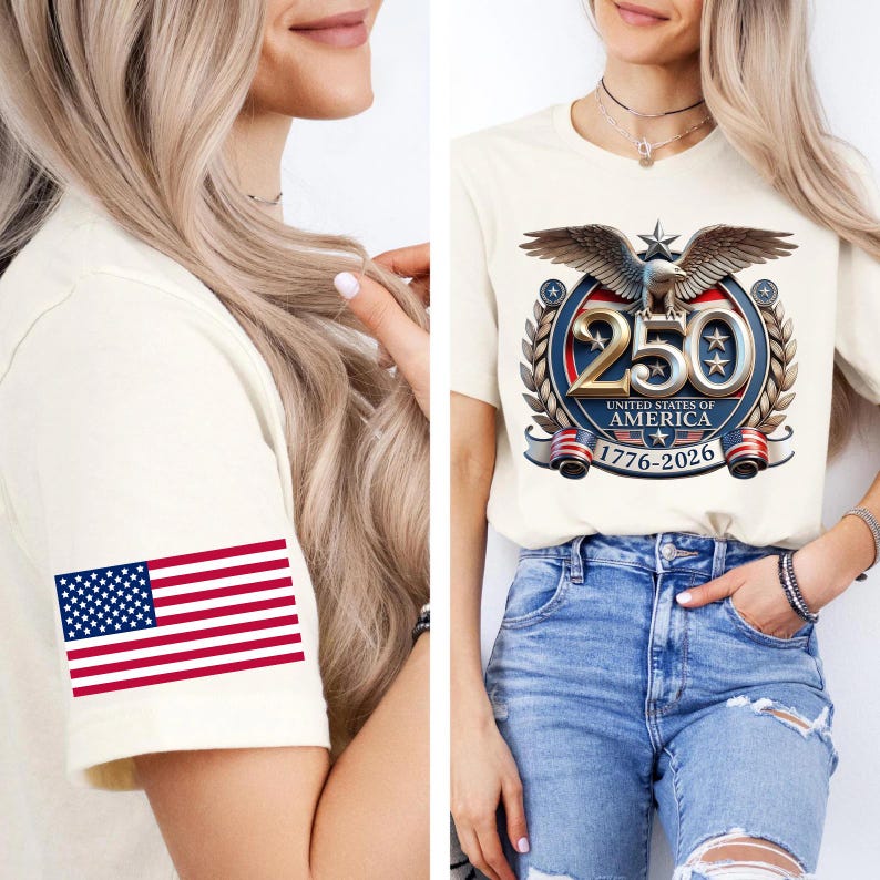 May include: Cream-colored t-shirt featuring a graphic commemorating the 250th anniversary of the United States of America. The design includes an eagle, stars, and the years 1776-2026. The sleeve displays a US flag.
