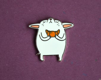 Small dog with a croissant enamel pin badge