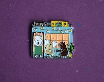 A cafe enamel pin badge