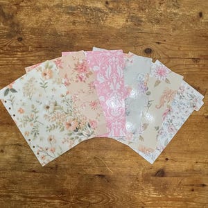May include: A set of six rectangular planner dividers with rounded corners and side tabs, featuring various floral and damask patterns in shades of pink, cream, and soft green. The dividers have punched holes along the left edge for binding.