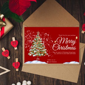May include: A red Christmas card with a watercolor illustration of a snow-covered Christmas tree. The card has the text "Thank You for your purchase Merry Christmas" and "May the spirit of Christmas bring hope, joy, and love to your heart and home".