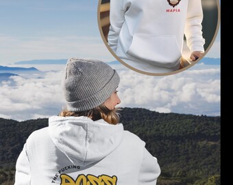 May include: White hooded sweatshirt with the text "I am the fucking boss mafia" in yellow and pink lettering on the back. The front of the sweatshirt has a cartoon monkey wearing a red bandana with the text "Mafia" underneath.