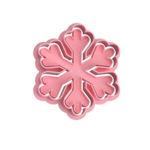 May include: A pink plastic snowflake cookie cutter with a detailed design.