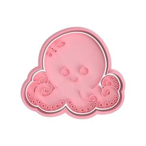 Może przedstawiać: Różowa plastikowa foremka do ciasteczek w kształcie ośmiornicy z uśmiechającą się twarzą i ośmioma mackami.