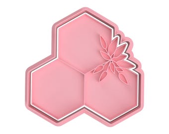 May include: A pink honeycomb-shaped design with a white outline and a floral cutout in the upper right corner.