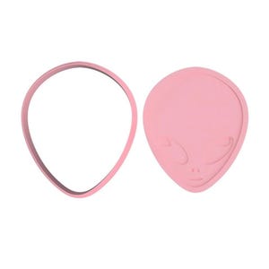 May include: A pink plastic cookie cutter shaped like an alien head. The cutter has a detailed face with eyes, nose, and mouth.