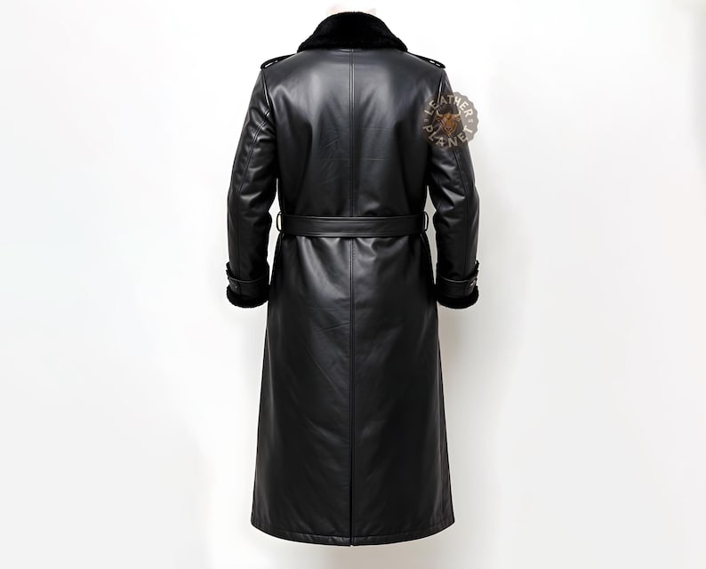 May include: A long black leather coat with a fur collar and a belt. The coat has a double-breasted closure and a long length.