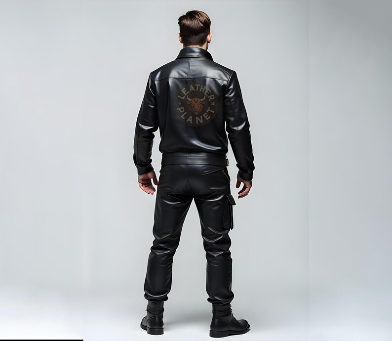 May include: A black leather jacket with a zipper closure and a logo on the back that says "Leather Planet". The jacket has a stand-up collar and long sleeves.