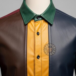 May include: A color-blocked leather shirt with a collared neckline. The shirt features panels of red, brown, yellow, navy, and green. The shirt has black buttons and a logo on the lower right side.