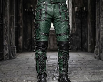 May include: Forest green trousers featuring black leather-like accents, multiple cargo pockets, silver-toned metal D-rings, and decorative chains. The lower legs include black lace-up panels with adjustable straps and buckles, paired with a matching belt.