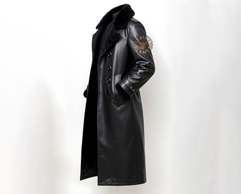 May include: A long black leather coat with a fur collar and a double breasted closure. The coat has a patch on the sleeve that says "Leather Planet".