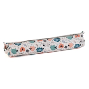 May include: A cylindrical pencil case featuring a pattern of sheep in teal, peach, and grey on a light grey background. The pencil case has a grey zip and trim.